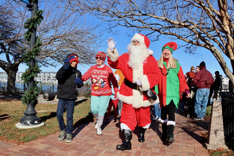 Santa Claus arrives in Lewes to kick off the holiday season Nov. 29. The jolly one came by Cape Water Taxi to the city dock, then led children and parents to his holiday home at Second and Bank streets. BILL SHULL PHOTOS
